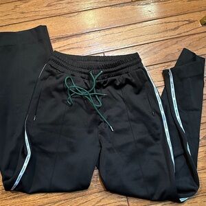 Pairing Black Track Pants with Green Drawstring small